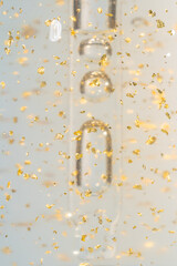 24k gold skin care serum in a glass bottle close up. Beauty treatment product texture macro.