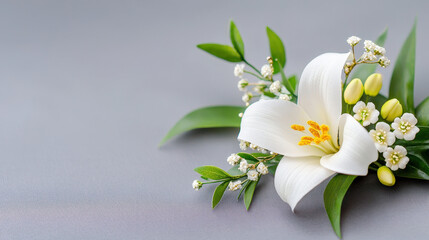 Fototapeta premium Delicate lily arrangement with white flowers, green leaves, and soft background creates serene and elegant atmosphere