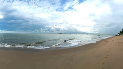 Serene Beach Coastal Landscape with Gentle Waves and Cloudy Sky
