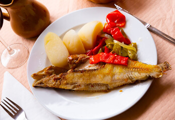 Spanish dish- roasted ballan wrasse fish (maragota) served with potatoes and vegetables