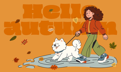 Warm autumn scene with a smiling girl walking her fluffy dog through puddles and fallen leaves
