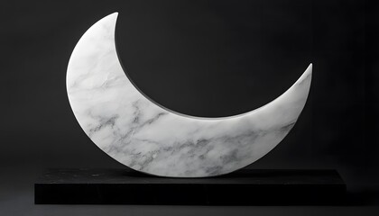 A polished, white marble crescent moon sculpture.