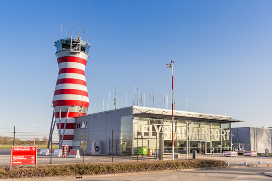 LELYSTAD, NETHERLANDS - APRIL 02, 2025: Red and white striped tower and terminal of the airport in Lelystad