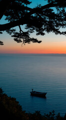 Serene coastal sunset scene featuring a boat on calm water underneath a silhouetted tree branch