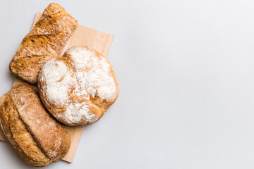 Homemade natural breads. Different kinds of fresh bread as background, top view with copy space