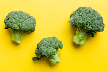 green fresh broccoli background close up on colored table. Vegetables for diet and healthy eating. Organic food