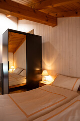 Interior of a double bedroom with two beds in a mountain hut.