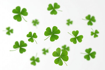 Festive clover and shamrock leaves flying, white background
