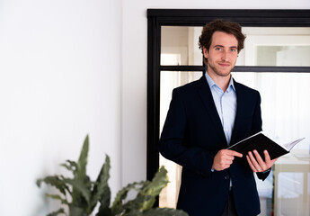 Professional man with a planner in hand, symbolizing organization and leadership.
