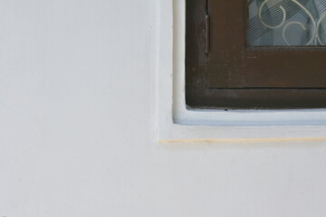 Architectural Detail of White Wall and Brown Window Frame With Copy Space