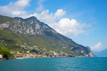 view of lake Gardasee and tourist resort Gargnano, Gargnano at the foot of the Cima Comer mountain