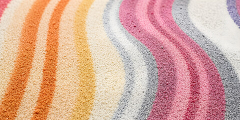 Close-up of rainbow sand strip on white background with copy space.