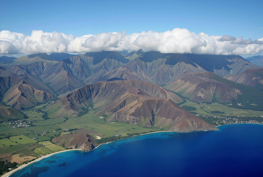 A breathtaking aerial view of a rugged mountain range with green valleys and a deep blue lake, surrounded by dramatic cliffs and a clear blue sky
