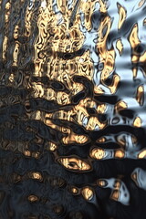 Distorted reflections of golden light on tranquil water at sunset