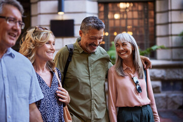 Smiling mature friends walking together outdoors