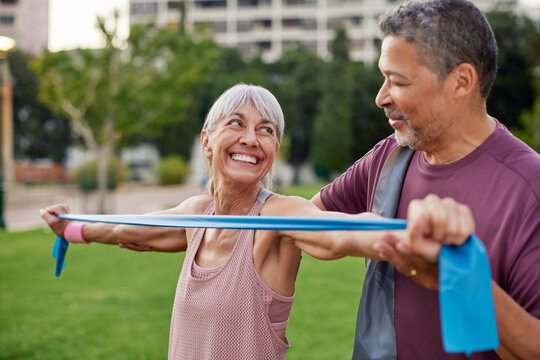 Healthy senior woman gets help from fitness instructor