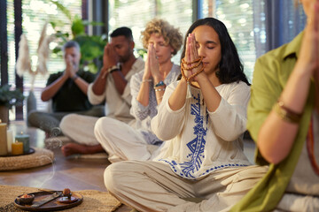 Meditation group with mala and clasped hands