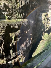 Water mist, golden sunlight, and a shimmering rainbow