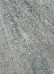 Dusty dirt ground with scattered small gravel. Natural texture with visible layers of soil. Ideal as a background or earth texture for design and illustration.