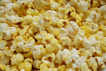 Close-up of freshly popped buttered popcorn. A golden, crispy, and tasty snack ideal for movie...