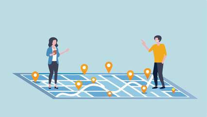 Fototapeta premium People standing on a large map with location pins discussing strategy and planning their next destination