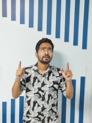 portrait of a young man standing in front of a wall