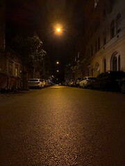 Budapest street scene at night with cars and street lights.