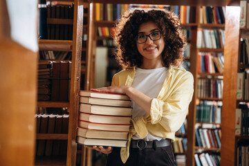 Beautiful woman is in the library
