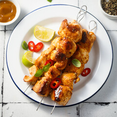 Chicken skewers with peanut and lime