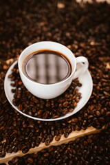 Close-up of roasted brown coffee beans falling against white background, showcasing texture, aroma, freshness, and energy for a morning brew.