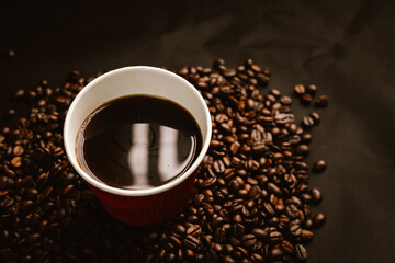 Close-up of roasted brown coffee beans falling against white background, showcasing texture, aroma,...