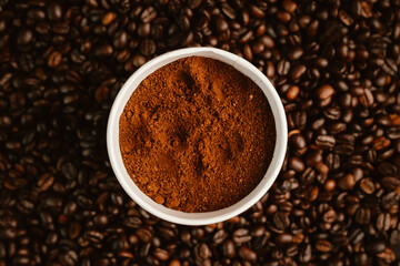 Close-up of roasted brown coffee beans falling against white background, showcasing texture, aroma, freshness, and energy for a morning brew.