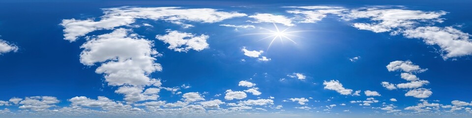 Spherical panorama of blue sky, loose cumulus clouds and sun shining 