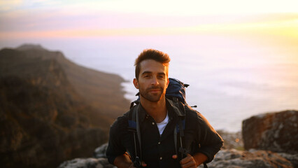 Hiking, smile and man with portrait outdoor for travel adventure, sightseeing and holiday trip. Sunrise, happy and person with backpack for trekking break, backpacker journey and relax at destination