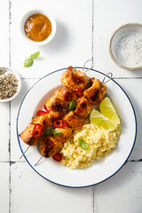 Chicken skewers with couscous and lime