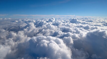 Ultra quality image of white thick clouds against blue sky from up high.