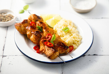 Chicken skewers with couscous and lime