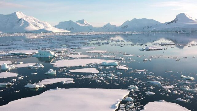 Melting icebergs and glaciers in polar regions highlight the impact of global warming on the environment. Large areas of water expose the consequences of climate change.