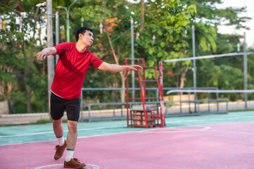 Obraz premium Asian male sepaktakraw player playing sepak takraw in outdoor court