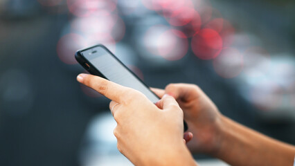Person, hands and typing with phone for communication, social media or chat on bokeh. Closeup, user or texting on mobile smartphone or wireless network connection for online research, browsing or app