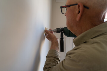 Elderly man engaged in DIY home improvement project