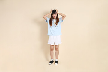20s Asian Woman in Light Blue Shirt and White Shorts