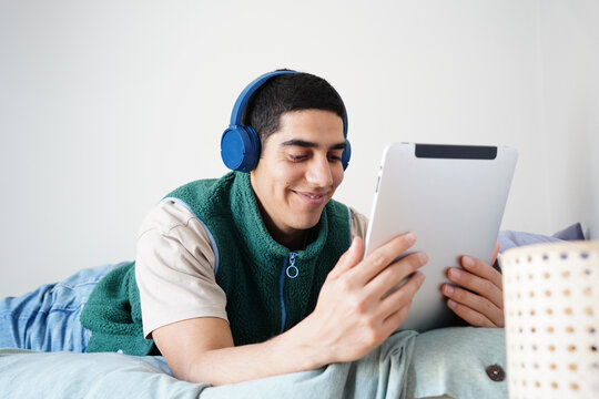 Arab man enjoying digital content on tablet