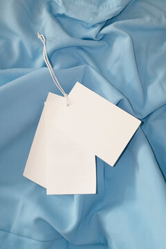 Blank tags on blue fabric background mockup