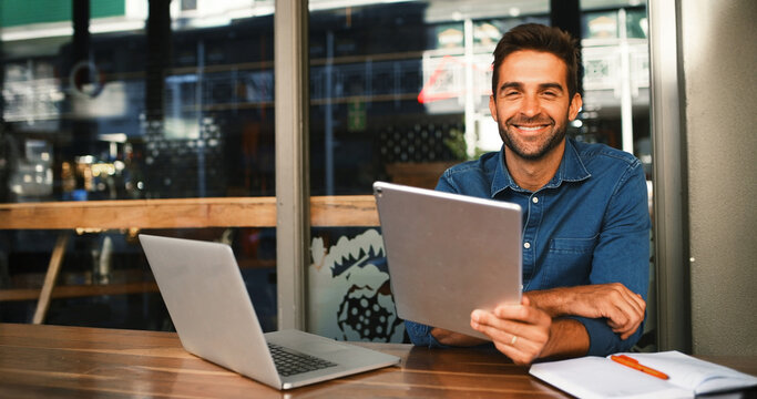 Fototapeta Portrait, smile and tablet with man in coffee shop to research for small business startup. Laptop, schedule and website with happy freelance employee person of cafe or restaurant as customer