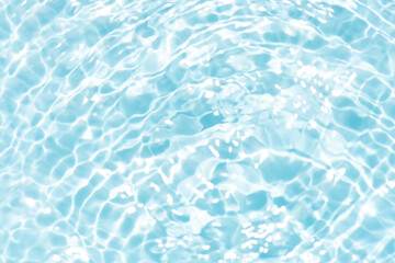 Blue water with ripples on the surface. Defocus blurred transparent blue colored clear calm water surface texture with splashes and bubbles. Water waves with shining pattern texture background.