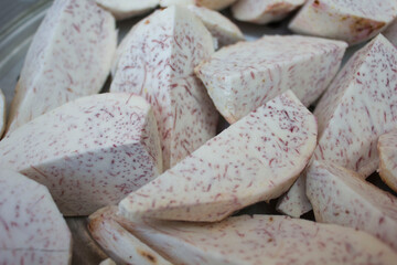 Freshly Cut Taro Roots. Close-up of freshly cut taro root pieces showing their speckled texture, ready for cooking or drying.