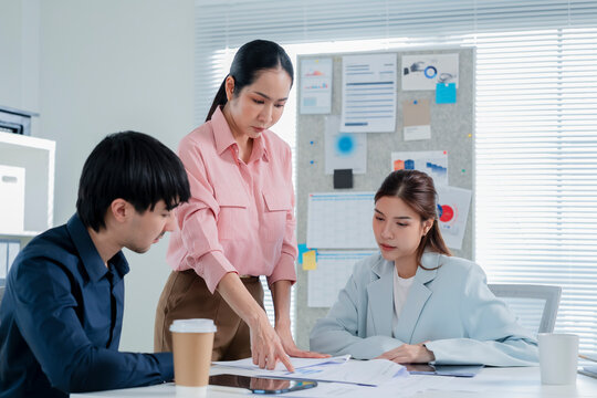 A diverse team of innovative business professionals gathers around a table in a sleek, modern office environment for a high-level brainstorming session focused on agile development strategies 