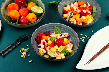 A vibrant shrimp salad featuring tropical fruits.
