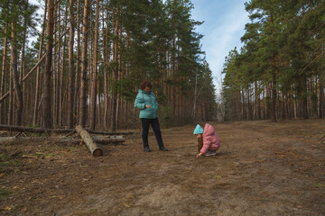 Grandmother with granddaughter walking in nature in the forest